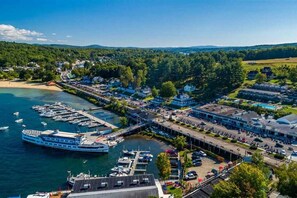 A waterfront town with a large ferry dock, residential buildings, and a marina.