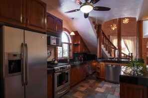 Enjoy cooking in this well-equipped kitchen with an oven, dishwasher, and stainless steel refrigerator.