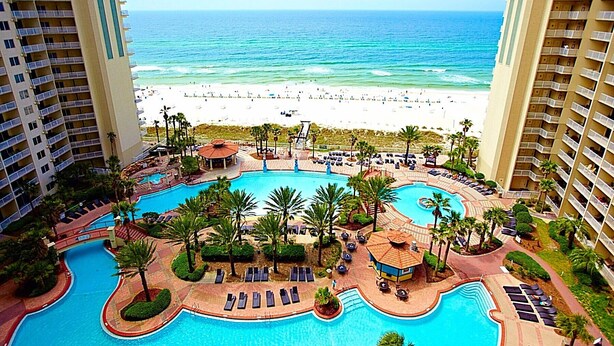 A resort with a central pool, lounge areas, and a beach view. - Spacious 9th floor, 2 bedroom plus bunkroom with STUNNING OCEAN & POOL VIEWS! (Panama City Beach)