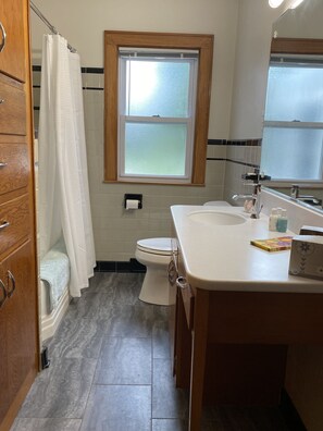 Combined shower/bathtub, towels, soap, toilet paper