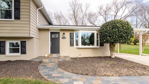 A two-story house with a front porch, a mailbox, and a well-maintained lawn. - 5 bedrooms with 4 Full Bath, Fire Pit,  BBQ and Plush Amen on 1/2 acre (Silver Spring)