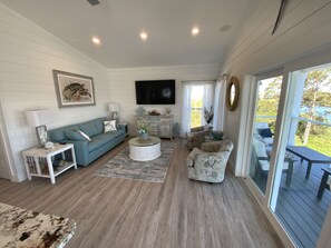 Relax in this inviting living room with a comfortable sofa, armchair, and flat-screen TV.