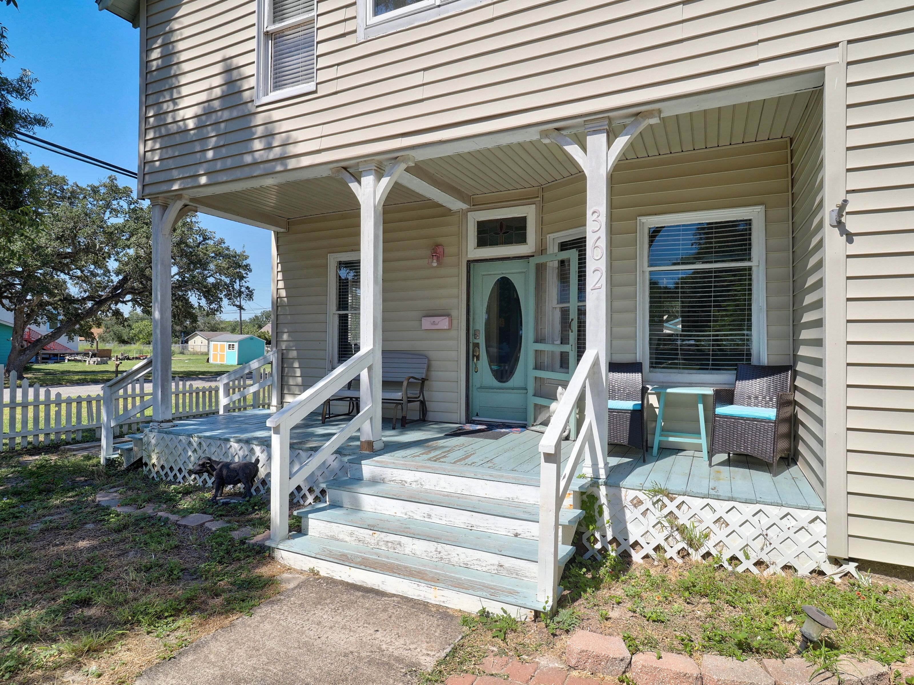 A house with a porch, a front door, and a mailbox.