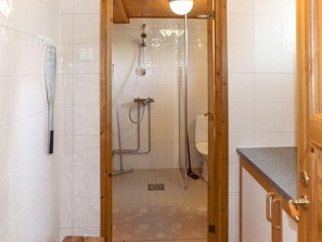 Bathroom features a shower, toilet, and towel rack.