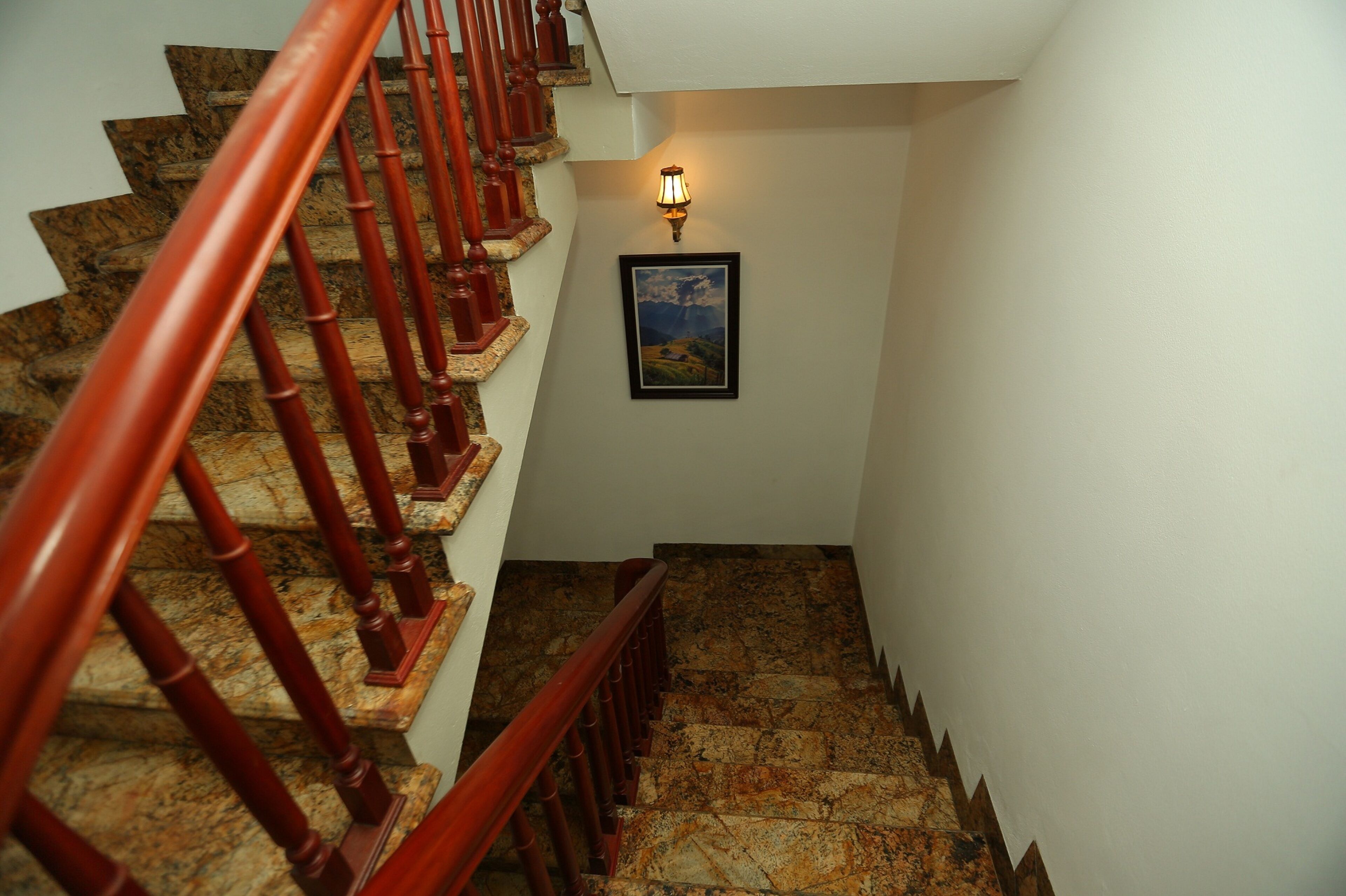 A staircase with wooden railings and stone steps.
