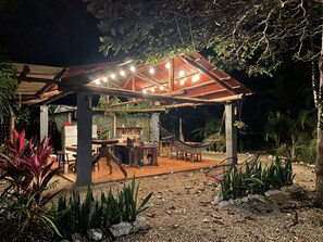 Outdoor dining - A rustic lodge surrounded by garden, nestled in a jungle setting - double Room 1 (Marbella)