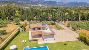 A house with a swimming pool, a patio, and a view of mountains. - Holiday Finca Can Salat Selva with Pool, Garden & Wi-Fi (Selva)