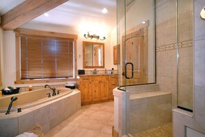 Bathtub, hair dryer, towels, shampoo