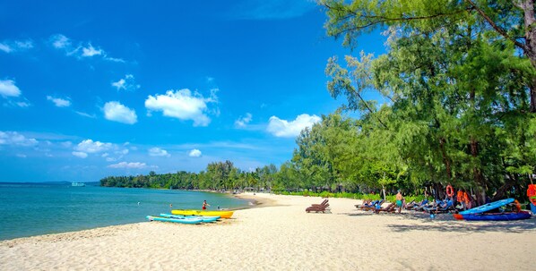 A beach with kayaks and lounge chairs. - Ocean Bay Phu Quoc Resort and Spa (Phu Quoc)