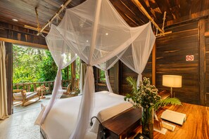 A room with a bed under a canopy, wooden walls, a balcony with seating, and a view of greenery. - Ocean Bay Phu Quoc Resort and Spa (Phu Quoc)