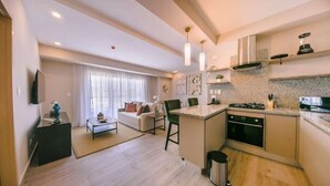 A modern apartment with a living area, kitchen, and dining space.