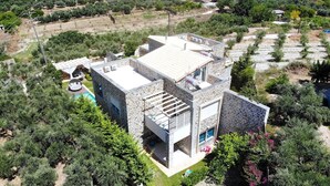 A modern two-story house with a stone facade, a flat roof, and a small balcony. - Blue Mare Villa, privacy and relaxation! (Rethymnon)