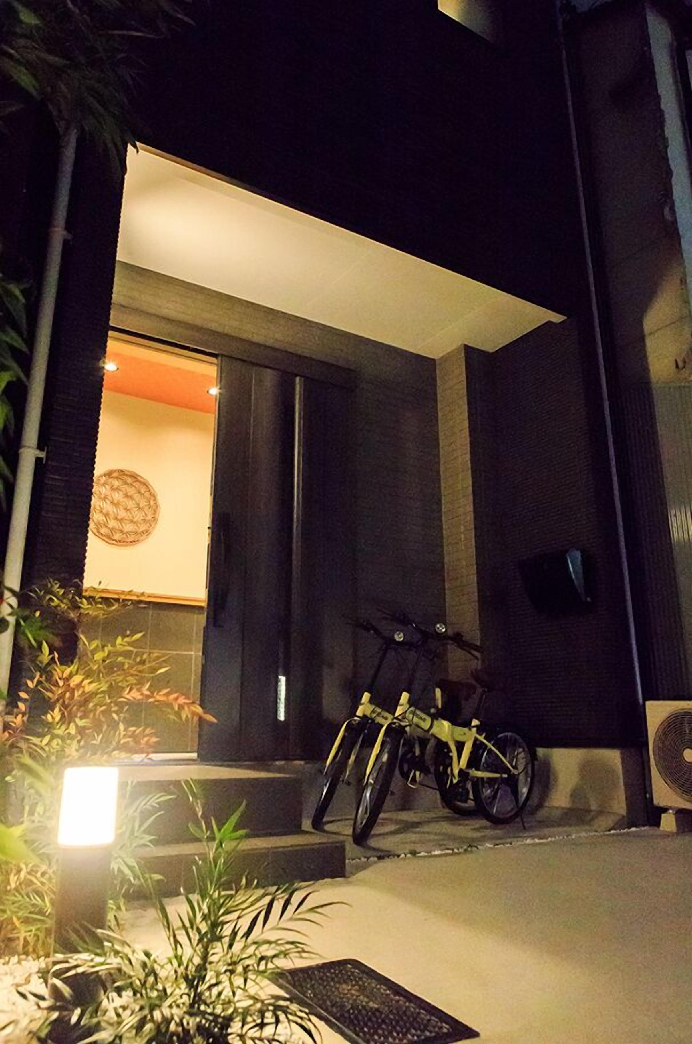 A modern building entrance with a bicycle parked outside.
