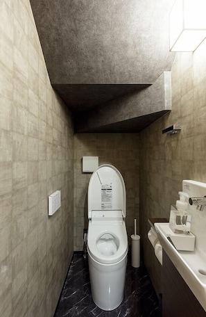 A compact bathroom with a toilet, bidet, and sink. - ORIGAMI STAY -Futatsubashicho- (Nagoya)