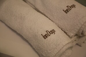 Economy Condo | Bathroom | Bathtub, hair dryer, slippers, soap