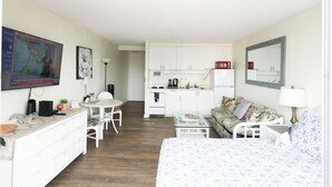 A compact hotel room with a bed, a small desk, a chair, a kitchenette, and a dining area. - 1610 🌸 free parking 🚙🅿️, fast WIFI💻 (Honolulu)