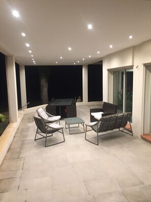 Relax and socialize in this inviting patio area with a fire pit and comfortable seating.