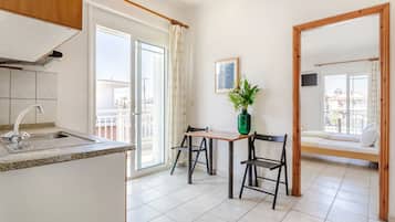 Economy Triple Room | Private kitchen | Mini-fridge, stovetop, cookware/dishes/utensils, cleaning supplies