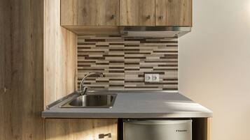 Mini-fridge, stovetop, electric kettle, cookware/dishes/utensils