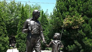 A statue of a man and a child holding hands, with a sign below stating "The Andy Griffith Story."