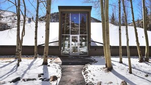 A modern building with a glass entrance surrounded by birch trees. - Huge condo in Keystone, sleeps 14, great location (Dillon)