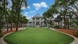 A golf course with a clubhouse, surrounded by trees and a water feature. - Marriott's Surf Watch - Luxury 2 BR, 2 Bath Villa w/ full kitchen that sleeps 8! (Hilton Head Island)