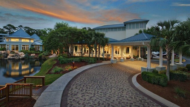 A waterfront hotel with a covered patio, a pond, and a landscaped garden. - Marriott's Surf Watch - Luxury 2 BR, 2 Bath Villa w/ full kitchen that sleeps 8! (Hilton Head Island)
