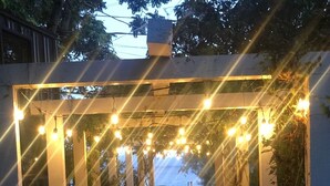 A pathway under a pergola with string lights, leading to a body of water. - ALL INCLUSIVE AMENITIES:Kayak,SUP,Pedal Boat,PingPong,Pickleball,Movie Nt &MORE! (Nice)