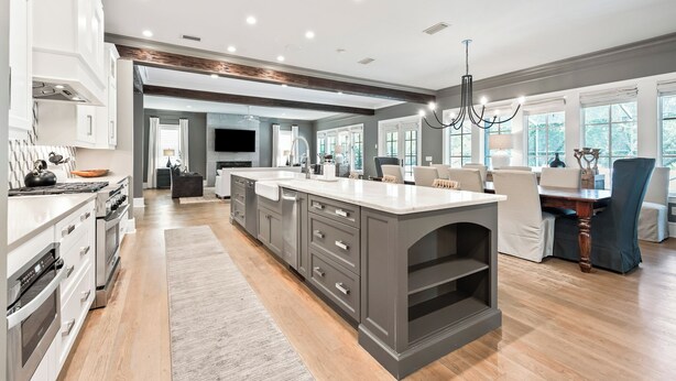 A spacious kitchen with a large island, modern appliances, and ample natural light from large windows. - Better on Brenda | Private Pool + Spa | Private Beach Access | 4 Bikes (Seacrest)