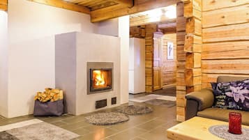 A cozy room with a fireplace, a sofa, and a table with a decorative item.