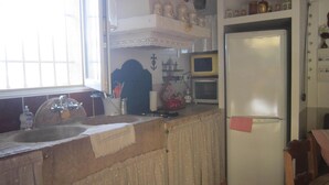 A kitchen with a sink, a microwave, and a refrigerator.