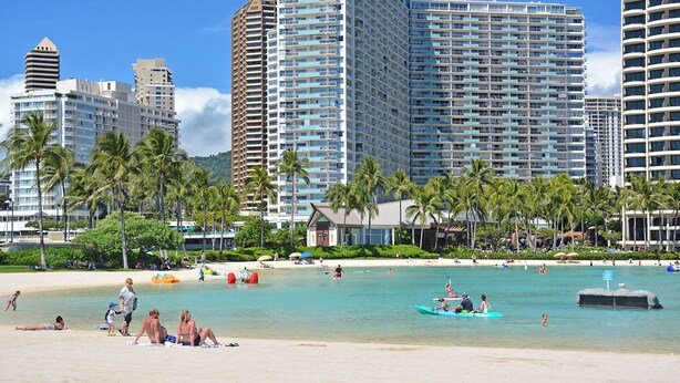 A beachfront hotel with high-rise buildings, palm trees, and a sandy beach. - CORNER Unit with 11th Floor Waikiki Ocean, Lagoon & Marina Views! Washlet! (Honolulu)