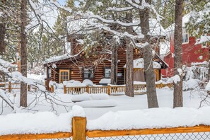 A log cabin surrounded by snow-covered trees. - Log Cabin with Hot Tub | Across from Aspen Glen | Near Village & Lake (Big Bear Lake)