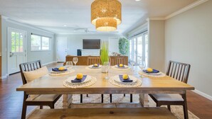 A dining room with a large wooden table set for six, surrounded by chairs. - Perfect for Wine Country Vacation Living and Entertaining (Santa Rosa)