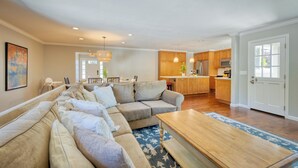 A spacious living room with a sectional sofa, a wooden coffee table, and a kitchen in the background. - Perfect for Wine Country Vacation Living and Entertaining (Santa Rosa)