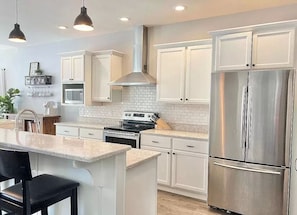 Fridge, microwave, oven, stovetop - Family Friendly lake home, beach, level lot, fire pit, game room, dog friendly! (Coloma)