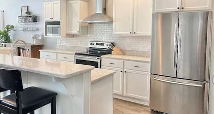 Family Friendly lake home, beach, level lot, fire pit, game room, dog friendly!