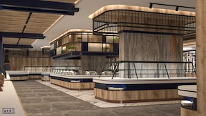 Un hall d’hôtel moderne avec un comptoir d’accueil central, plusieurs espaces de détente et une grande colonne en bois.