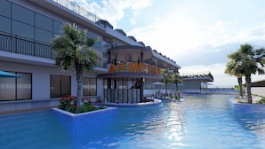 Un hôtel moderne doté d'un espace piscine, d'une enseigne « ARMELL » bien visible, de sièges en plein air et de palmiers.