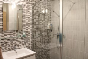Shower, hair dryer, towels, toilet paper