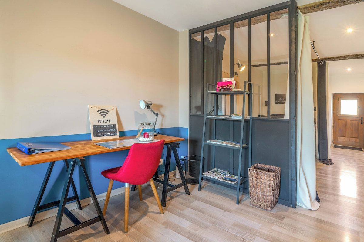 A room with a desk, chair, and a bookshelf.