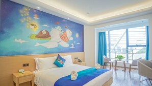 A hotel room with a large mural of a polar bear and a dog on a bed, a wooden nightstand with a phone, a table with chairs, and a large window with curtains. - Sanya Discovery Ocean World (Sanya)