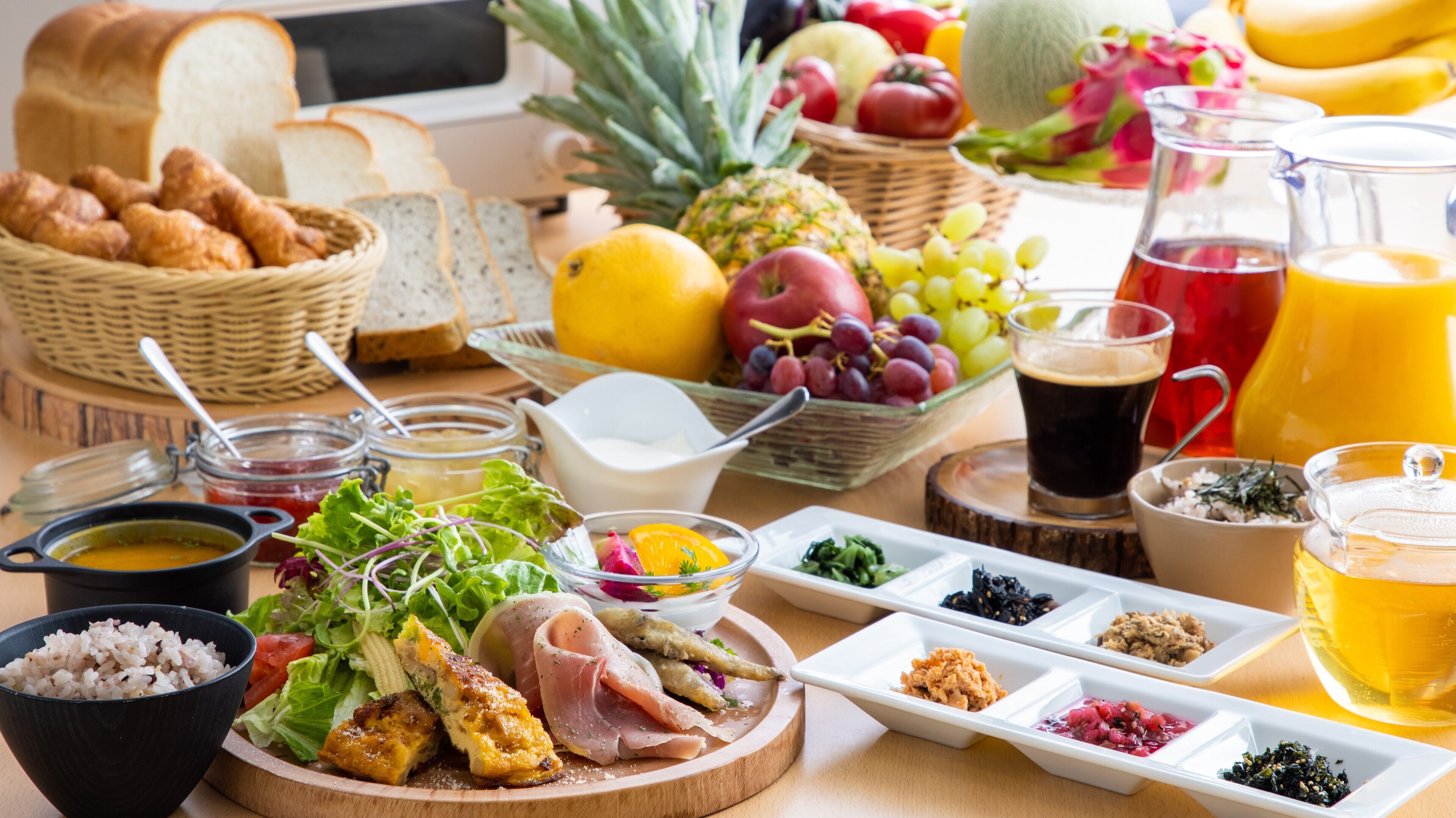 A breakfast spread with various foods and drinks.