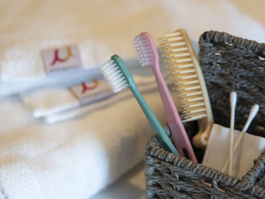 A basket containing two toothbrushes and a comb.