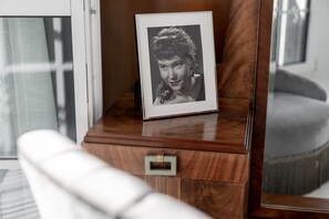 A framed photograph on a wooden dresser with a drawer. - Ruby Mimi Hotel Zurich by IHG (Zürich)