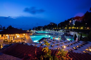 A resort with a large swimming pool, lounge chairs, and a bar area. - Viva Mare Beach Hotel (Sozopol)