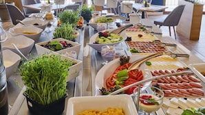 A buffet with various food items and utensils. - Viva Mare Beach Hotel (Sozopol)
