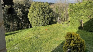 A garden with a bell, a statue, and a variety of trees and shrubs. - Studio (st crepin carlucet)
