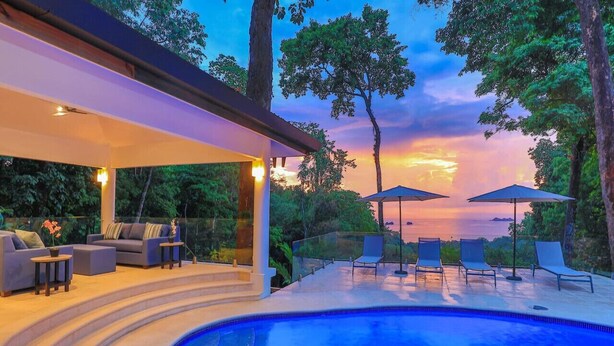 A modern outdoor pool area with lounge chairs and a covered seating area. - NEWLY REMODELED GRAND OPENING PRICING
4 Bedroom villa (Uvita, Ballena, Puntarenas,)