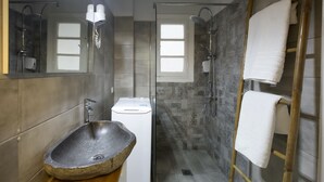 A modern bathroom with a stone sink, a glass shower enclosure, and a wooden ladder for storage. - Apollonos Amalia Studio - Apollonos Studio (Athens)